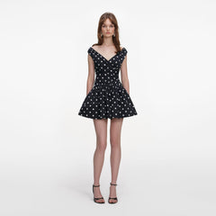 Front view of a woman wearing the Black Polka Dot Cotton Mini Dress