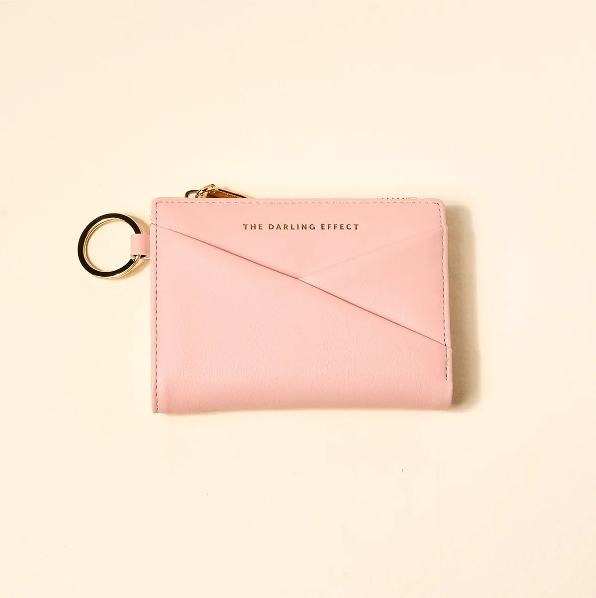 blush colored luxe pocket wallet on a beige background