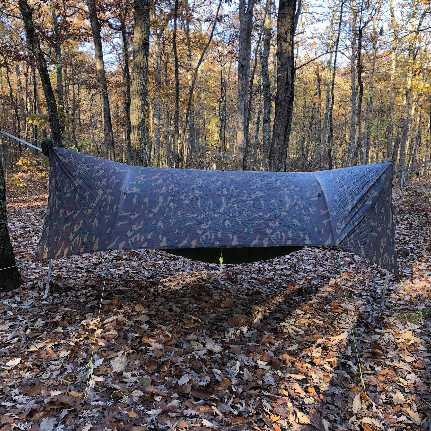 Jacks R Better 12 by 10 foot Universal Tarp pitched over a campsite