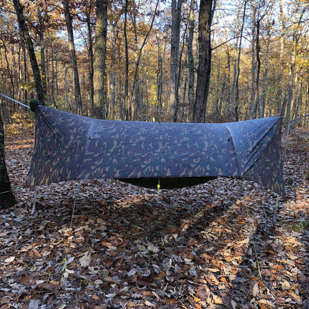 Jacks R Better 12 by 10 foot Universal Tarp pitched over a campsite